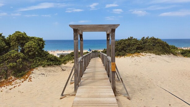 A wooden boardwalk leading to a beach with clear skies. - Villa Tres Mares - Extraordinary accommodation. (Poblado de Sancti Petri)