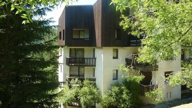 A multi-story building with a modern design, featuring balconies and large windows. - Studio N° 213 LES Flocons (LES ORRES 1650)