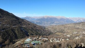A mountainous landscape with a small village and a ski resort.