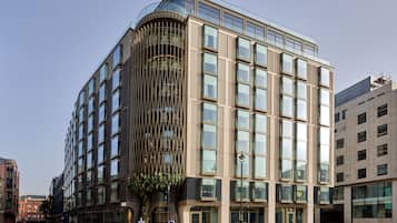 Distinctive building with a curved facade and grid-like windows.