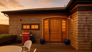 A wooden deck with a grill, two potted plants, and a table with chairs. - Step into historic magic at this renovated post-and-beam loft in downtown Newport RI! Open floor plan, cozy beds, full kitchen, two decks for outdoor dining, mini-split AC, TVs. Steps to Thames Street, shops, wharfs—Superhost (Newport)