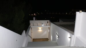 A staircase leading to a covered area with a light fixture above. - Villa *K*  SeaView and Pool. (VLYCHA)