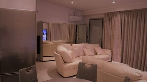 A modern living room with a sofa, a dining table, and a TV. - Villa *K*  SeaView and Pool. (VLYCHA)