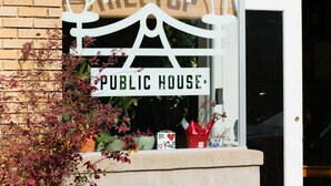 A public house sign with a coffee cup and a bed symbol, indicating a possible lodging facility. - Come back to peace after busy days at Maxwell or downtown. (Montgomery)