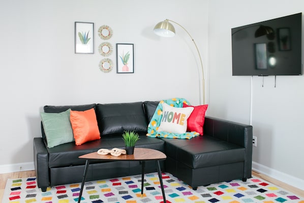 Relax in this stylish living room with a comfortable sofa, coffee table, and flat-screen TV.