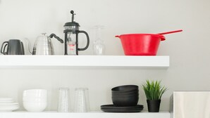 A kitchen with white cabinets, a coffee maker, a red pot, and a white refrigerator. - Come back to peace after busy days at Maxwell or downtown. (Montgomery)