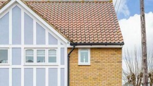 A two-story house with a garage, a tiled roof, and a brick facade. - Hertford - Sleeps 2 - 92 Walking Score - Garden (Hertford)