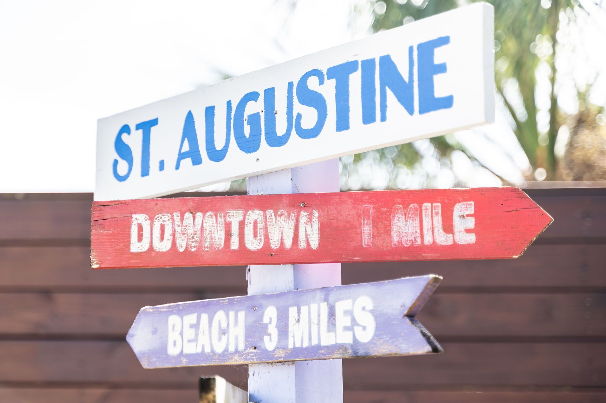 A directional sign with destinations: St. Augustine, Downtown 1 mile, and Beach 3 miles.