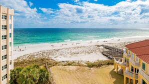 A beach view from a hotel with a clear sky, sandy beach, and ocean. - Regency Towers #708 West | Gulf Views, Pool! (Pensacola Beach)
