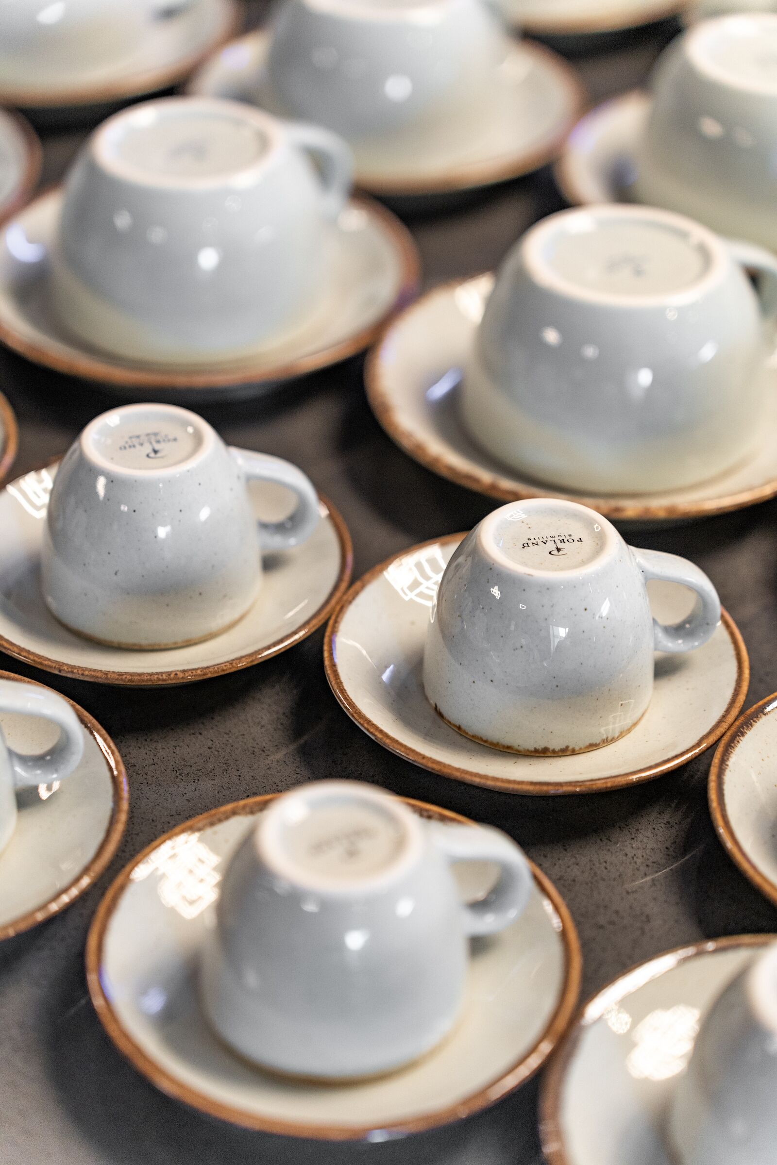 A collection of ceramic cups and saucers arranged on a table.