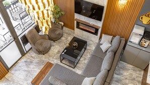 Una sala de estar moderna con chimenea, un sofá, una mesa de centro y un televisor.