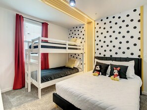 Themed Bedroom with Bunk Beds and Polka Dot Accent Wall