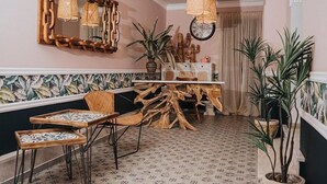 A dining area with a wooden table, chairs, and a mirror. - Parthenon Art Executive Wing (Katerini)
