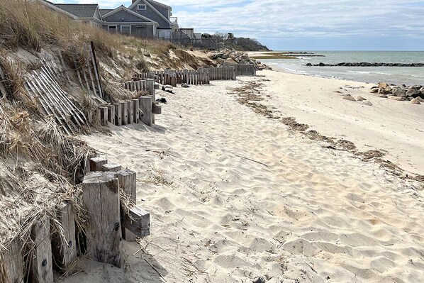 Enjoy access to the beach from this property, with a wooden fence separating the shoreline from the residential area.