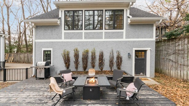 A house with a deck featuring a fire pit, outdoor seating, and a grill. - Tudor Style Carriage House  (Ann Arbor)