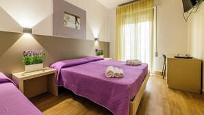 A hotel room with two beds, a desk, a TV, and a window with curtains. - Vinsea Hotel (Bellaria-Igea Marina)
