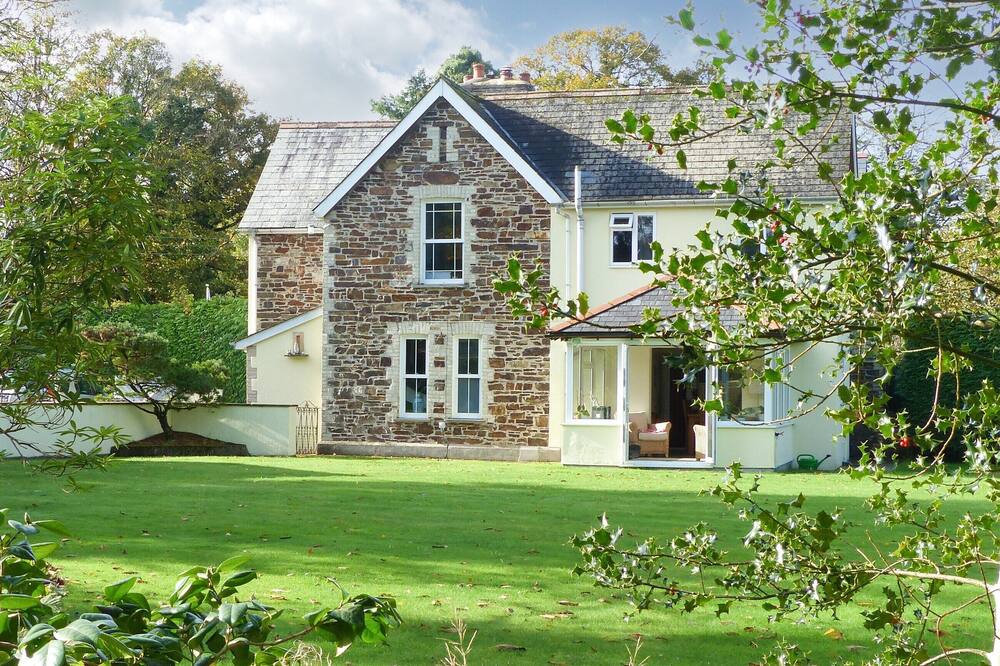 A rural retreat in a woodlands with large gardens.