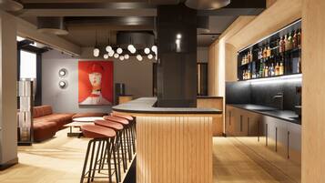 A modern kitchen with a central island, bar stools, and a liquor display.