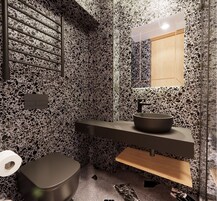 Un baño moderno con piso de terrazzo, lavamanos negro y tocador de madera.