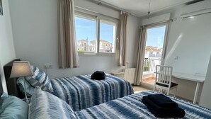 A room with two beds, a desk, a chair, and a window with curtains. - Villa with private pool & jacuzzi - CA27LT (Torre-Pacheco)