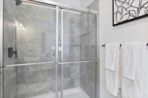 Shower, hair dryer, towels, shampoo