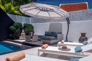 A modern outdoor lounge area with a pool, lounge chairs, a sofa, and an umbrella. - Villa Sabine private pool 4br seaview (Rawai)