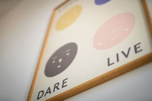 A framed picture with the word "LIVE" and a partial word "DARE" visible.