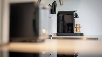 A coffee machine on a countertop with a reflective surface.