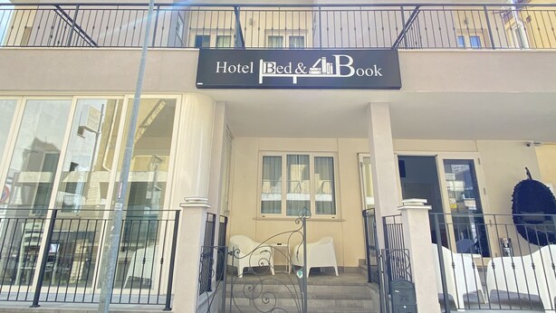 A hotel with a sign reading "Hotel Bed & Book" above the entrance. - bed and book (Rimini)