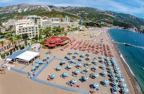 On the beach, beach shuttle, sun loungers, beach umbrellas