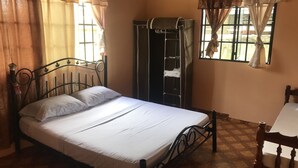 A room with a bed, a wardrobe, and a window with curtains. - B&B rent rooms  (Chaguanas)
