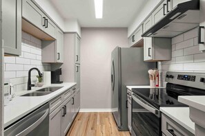 Fridge, coffee/tea maker, cookware/dishes/utensils, dining tables