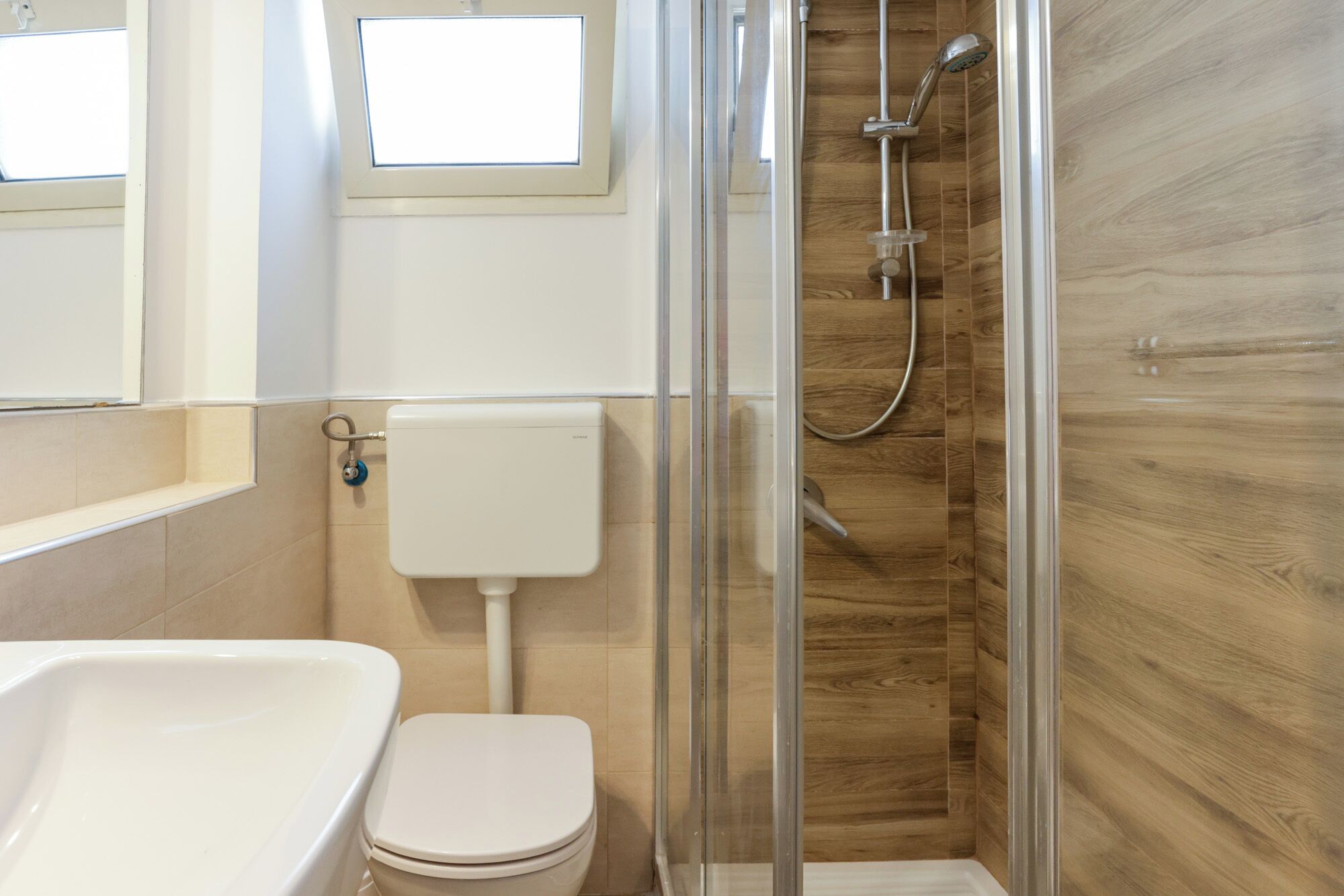 A bathroom with a toilet, a shower, and a bathtub.