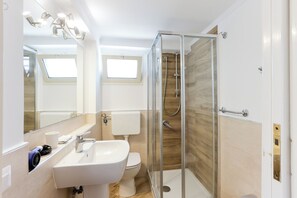 Een douche, een haardroger, een bidet, handdoeken