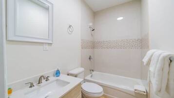 Combined shower/tub, hair dryer, towels, soap