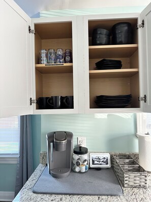 Efficient kitchen with ample storage and a granite countertop.