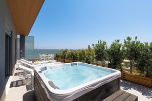 A rooftop terrace with a hot tub, outdoor seating, and a view of the sea. - Rhodes Skyline Suite With out Door Jacuzzi Sea View (Rhodes)