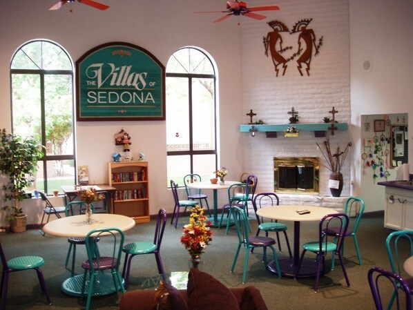 Relax in comfort with a fireplace, large window, and cozy seating areas.