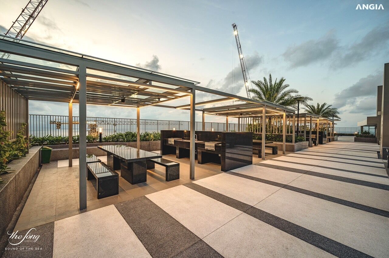 A rooftop terrace with outdoor seating and a view of the sea.