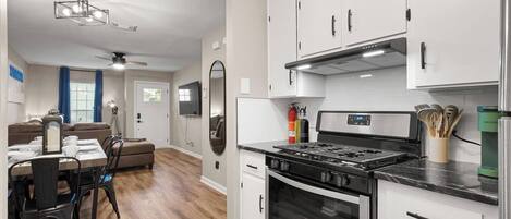 Fridge, coffee/tea maker, cookware/dishes/utensils, dining tables