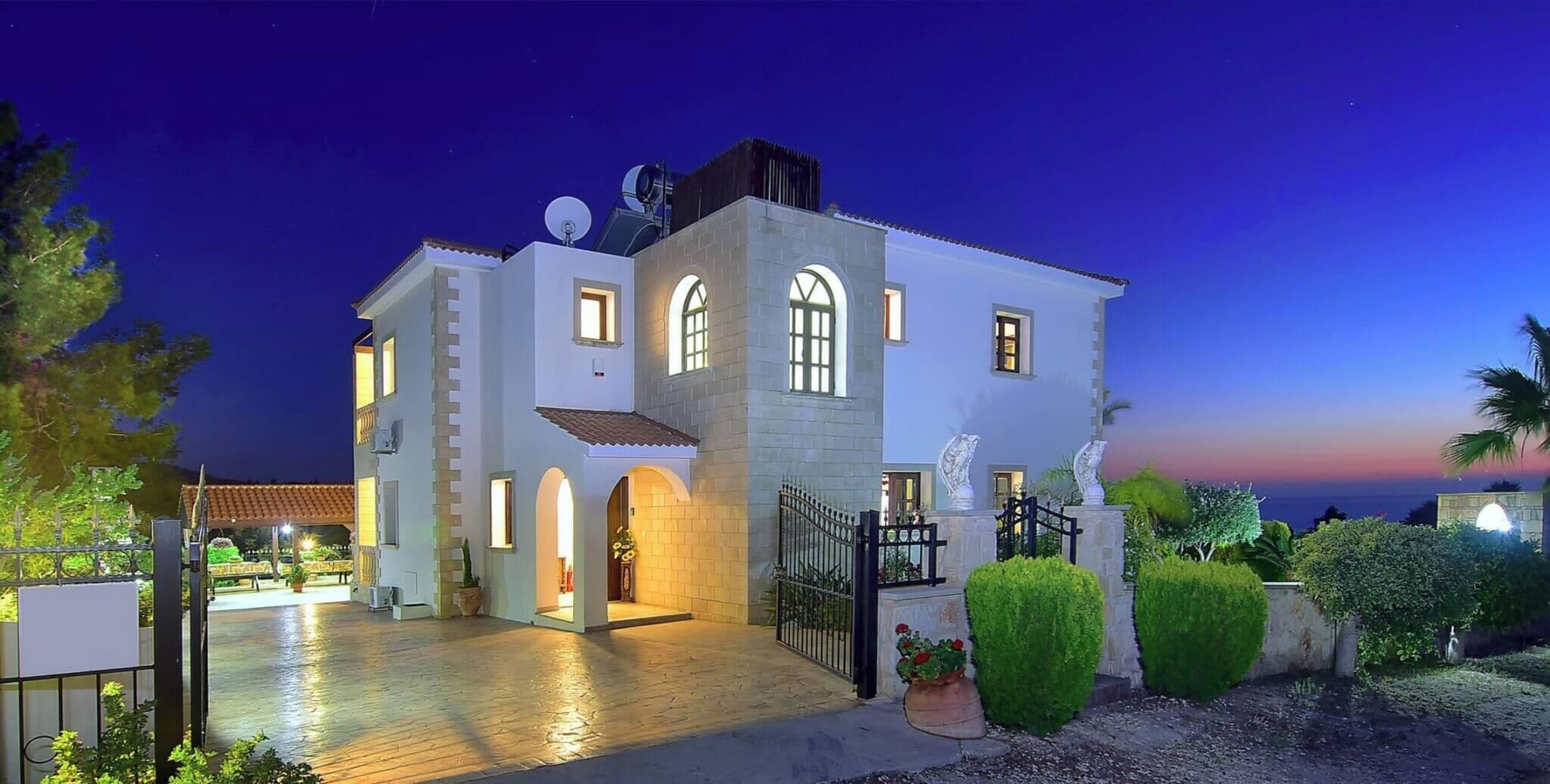 A two-story building with a courtyard, a gated entrance, and a satellite dish.