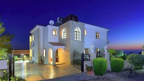 A two-story building with a courtyard, a gated entrance, and a satellite dish. - Away-from-it-all, Exceptional Sea Views Sleeps 10 (Ayia Marina Chrysochous)