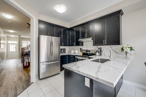 Family House | Private kitchen | Full-size fridge, microwave, oven, stovetop - Aaira Suites 4 Bedroom (Brampton)
