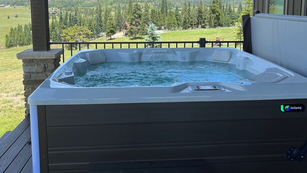 A hot tub on a wooden deck with a mountain view. - Views, views, views!!!  Secluded setting over-looking beautiful Steamboat Lake. (Clark)