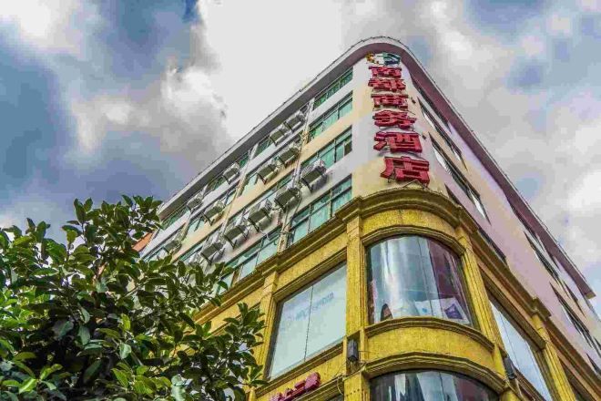 A multi-story building with a prominent red sign on the facade.