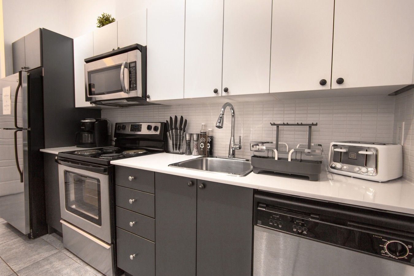 A modern kitchen with a built-in microwave, stove, and dishwasher.