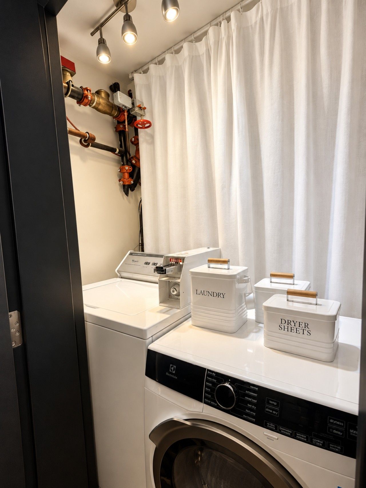 A laundry area with a washing machine, dryer, and storage bins labeled 'LAUNDRY' and 'DRYER SHEETS.'