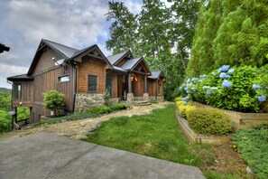 Escape to a serene forest retreat with a cozy cabin surrounded by lush greenery and a welcoming porch.