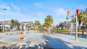 An outdoor water play area with multiple water jets and colorful structures. - Awesome Villa 5Beds/5Bath/Pool/Jacuzzi/5Min From Disney (Kissimmee)