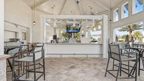 A covered outdoor seating area with a bar, chairs, and a tiled floor. - Awesome Villa 5Beds/5Bath/Pool/Jacuzzi/5Min From Disney (Kissimmee)